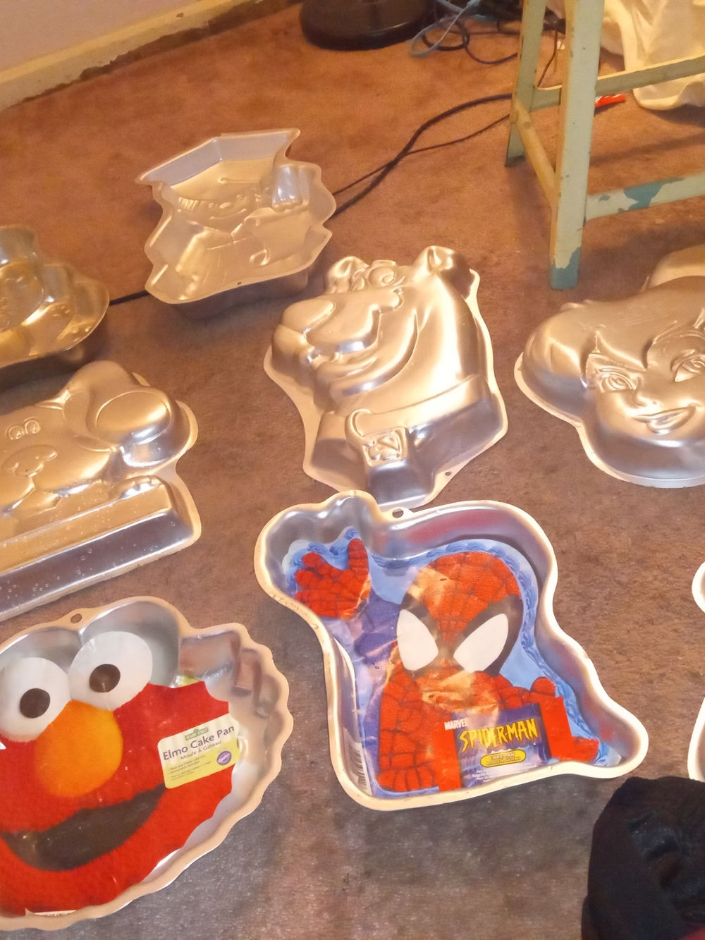 Collection of aluminum cake pans featuring various children's characters